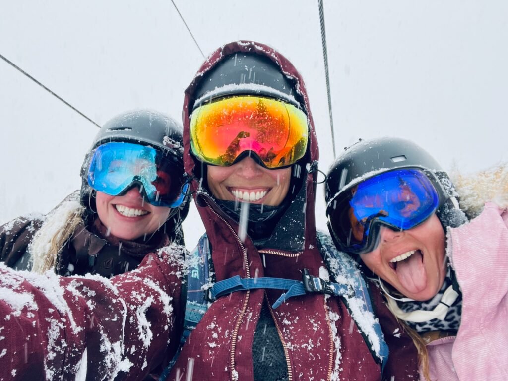 women chairlift powder day ski trip